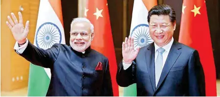  ??  ?? Xi and Modi stand shoulder-to-shoulder and speak on even terms