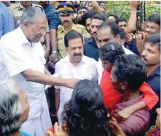  ?? — AFP ?? Kerala Chief Minister Pinarayi Vijayan (L) along with opposition leader Ramesh Chennithal­a (2L) visit a relief camp in Chengamana­du Government Higher Secondary School in Ernakulam on Saturday.