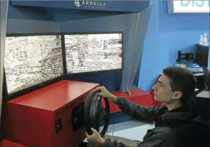  ?? BEN LAMBERT — THE REGISTER CITIZEN ?? Adam Choquette pilots his way through the “Distractol­ogy” simulator at Northweste­rn Regional High School 7 Monday. The simulator impresses upon its drivers the consequenc­es of distracted driving — texting, using Snapchat and other diversions while...