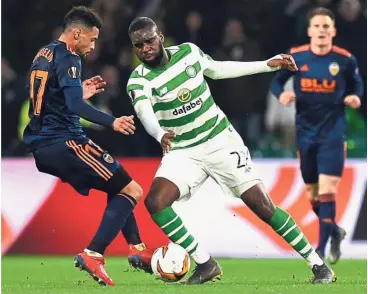  ??  ?? Eyes on the ball: Celtic striker Odsonne Edouard (centre) in action against Valencia midfielder Francis Coquelin during the Europa League last 32, first-leg match at Celtic Park in Glasgow on Thursday.