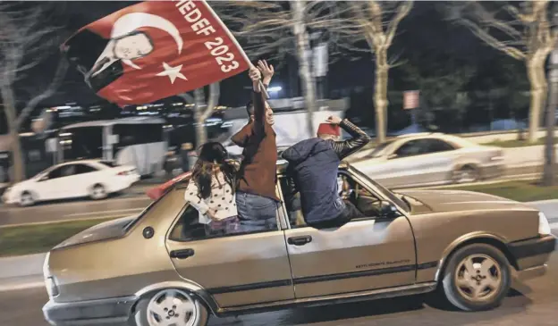  ?? PICTURE: OZAN KOSE/AFP/GETTY IMAGES ?? 0 A supporter of Turkish president Recep Tayyip Erdogan’s Justice and Developmen­t Party celebrates near a rally in Istanbul