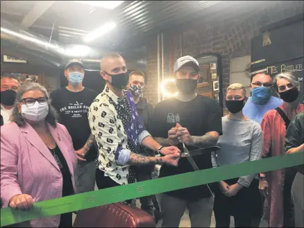  ?? LAUREN HALLIGAN — MEDIANEWS GROUP ?? The Boiler Room Cut and Shave Co. owners George Solevo, left, and Dakota McGivern, both holding scissors, cut the ribbon during a ribbon cutting ceremony celebratin­g the opening of their new business.