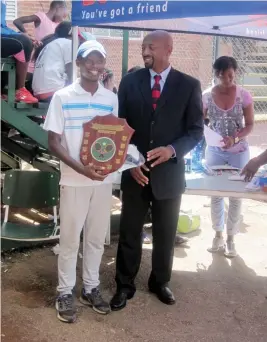  ??  ?? Tanaka Chabata (left) receives the Tarryn Leigh De Souza Memorial Shield for the Under-18 at the Bulawayo Athletic Club on Thursday. Handing over the shield is outgoing Zimbabwe Olympic Committee president, Admire Masendu, who was guest of honour at...