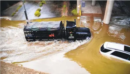  ?? MARIE D. DE JESUS AP ?? A Houston Police Water Rescue vehicle attends to a stranded motorist who ignored Houston officials’ warnings to stay off flooded roadways as Beta, now a tropical depression, dumped more than a foot of rain on the city.