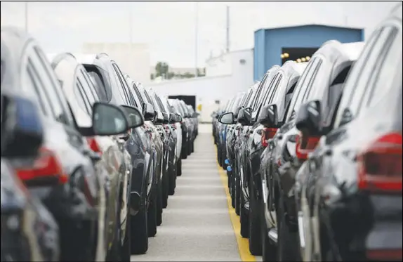  ?? PHOTOS BY DUSTIN CHAMBERS / THE NEW YORK TIMES ?? BMW vehicles made in Spartanbur­g, S.C., await loading Monday at the port of Charleston. The German company — not an American icon like Ford or General Motors — is now the largest exporter of cars made in the United States. But BMW’s output in America is threatened by the global trade war started by President Donald Trump.