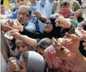  ?? PHOTO: REUTERS ?? Egyptians gather to buy subsidised sugar from a government truck after a sugar shortage in retail stores across the country.