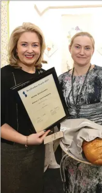  ??  ?? Karen Hennessy hands over an award to Asta Gauronskyt­e of Old Court Linens in Blessingto­n.