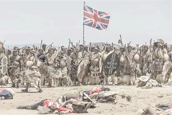  ?? MARCO LONGARI/AGENCE FRANCE-PRESSE ?? AMABUTHO Zulu regiments hold a British flag captured during the reenactmen­t of the Battle of Isandlwana, in Isandlwana, South Africa. The battle, fought on 22 January 1879 was the first major encounter in the Anglo-Zulu War between the British Empire and the Zulu Kingdom.