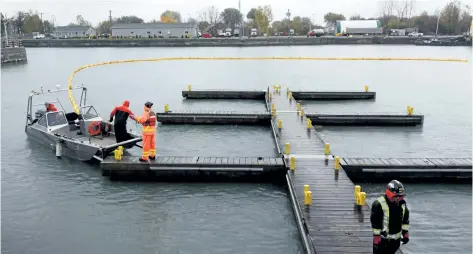  ?? DAVE JOHNSON/WELLAND TRIBUNE ?? A yellow boom is stretched across the Welland Canal south of Bridge 21 Wednesday in Port Colborne during an emergency training exercise. Officials from St. Lawrence Seaway Management Corp., Port Colborne Fire and Emergency Services, Niagara Emergency...