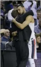  ?? BEN MARGOT — THE ASSOCIATED PRESS ?? Gonzaga guard Nigel WilliamsGo­ss, right, is hugged by head coach Mark Few in the closing minutes Saturday in San Jose, Calif.