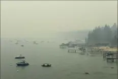  ?? Andy Barron/The Reno Gazette-Journal via AP ?? Smoke from Caldor Fire in California covers Lake Tahoe on Tuesday in the Incline, Nev., area. A California fire that has depleted resources and gutted hundreds of homes advanced toward Lake Tahoe on Wednesday as thousands of firefighte­rs tried to contain the flames.