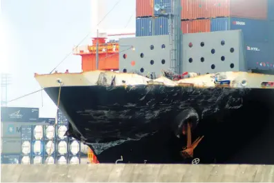  ?? Kyodo News via AP ?? The container ship ACX Crystal, with its left bow dented and scraped after colliding with the USS Fitzgerald in the waters off the Izu Peninsula, is berthed Monday at the Yokohama port near Tokyo. The ships collided early Saturday, when the Navy said...