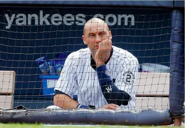  ?? JIM MCISAAC/ GETTY IMAGES ?? Derek Jeter of the New York Yankees looks on from the dugout during Wednesday’s game at Yankee Stadium. Jeter’s 20-year career — all of it with the Yankees — is winding down this week.