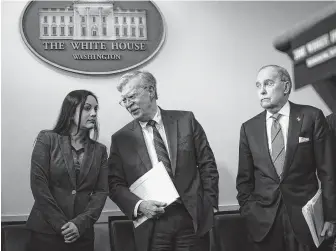  ?? Al Drago / Bloomberg ?? John Bolton, center, national security adviser, and Larry Kudlow, director of the National Economic Council, arrive to a White House briefing. President Donald Trump will meet with Chinese President Xi Jinping and other leaders in Argentina this weekend.