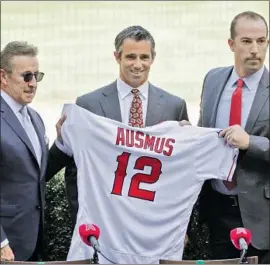  ?? Myung J. Chun Los Angeles Times ?? NEW MANAGER Brad Ausmus, with Angels owner Arte Moreno, left, and general manager Billy Eppler, right, has the task of trying to rekindle the club.