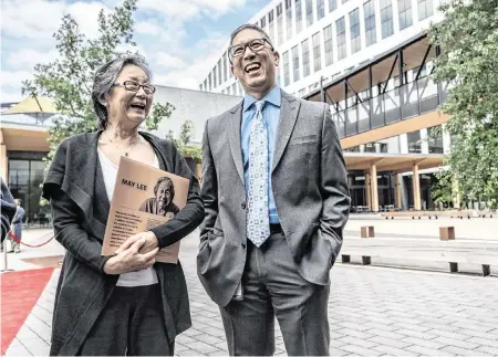  ?? HECTOR AMEZCUA hamezcua@sacbee.com ?? Robin Fong, left, holds a replica of a plaque about her aunt – former state worker May Lee – that hangs in the lobbies of the new state office complex that bears Lee’s name, as she joins her cousin Chris Lee for the grand opening Wednesday in Sacramento’s River District. The May S. Lee State Office Complex is named after the state’s longest-serving employee, who had 79 years of service and learned that the buildings would be named after her before her death at age 102.