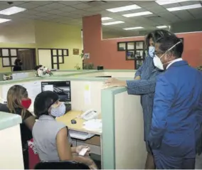  ??  ?? Staff of the Jamaica Intellectu­al Property Office rap with minister of state in the Ministry of Industry, Investment and Commerce, Dr Norman Dunn (right), as executive director of the office, Lilyclaire Bellamy stands next to Dr Dunn in observance.