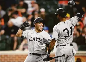  ?? Nick Wass / Associated Press ?? The Yankees’ Jose Trevino, left, celebrates his three-run home run with teammate Aaron Hicks during the fourth inning against the Orioles on Monday.