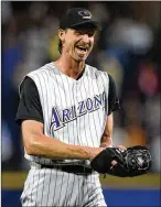  ?? AJC 2004 ?? Arizona’s Randy Johnson reacts to the final out of his perfect game in 2004 against the Braves at Turner Field, after which he received a standing ovation from Atlanta fans.