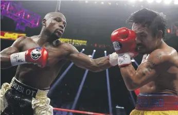  ?? AP ?? A win against Adrien Broner in Las Vegas on Saturday could earn Manny Pacquiao a rematch with Floyd Mayweather Jr, left, after having lost to him in a record-breaking duel in May 2015