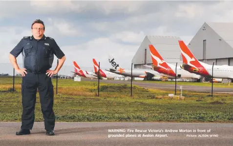  ?? Picture: ALISON WYND ?? WARNING: Fire Rescue Victoria’s Andrew Morton in front of grounded planes at Avalon Airport.