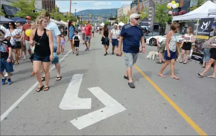  ?? The Okanagan Weekend ?? Crowds mingle along Bernard Avenue during the 27th annual Block Party in 2016. Bernard is closing to vehicle traffic on Monday, and Tourism Kelowna is urging vacationer­s to visit the city now that B.C. has entered phase 3 of the province’s re-opening plan.