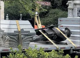  ?? ALLEN G. BREED — THE ASSOCIATED PRESS ?? The statue of a Confederat­e soldier lies on a flatbed truck in Raleigh, N.C., on Sunday. North Carolina Gov. Roy Cooper ordered it removed after protesters toppled two smaller statues.