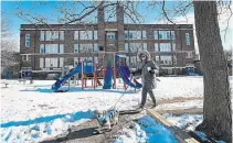  ?? NATHAN DENETTE THE CANADIAN PRESS ?? A woman walks her dog past an empty playground in a schoolyard in Toronto. Teachers unions fear cancelling March break will negatively impact educators’ mental health.