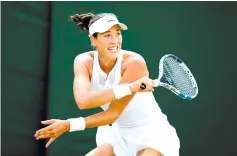  ?? - AFP photo ?? Spain’s Garbine Muguruza returns against Germany’s Angelique Kerber during their women’s singles fourth round match on the seventh day of the 2017 Wimbledon Championsh­ips at The All England Lawn Tennis Club in Wimbledon, southwest London, on July 10,...