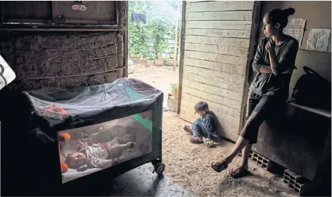  ?? PHOTOS: MERIDITH KOHUT/THE NEW YORK TIMES ?? ABOVE Johanna Guzman, 25, takes care of her children at her home in the mountains outside Caracas. ABOVE LEFT Abortion pills for sale on the black market.