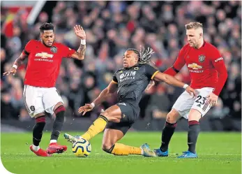  ??  ?? Wolves’ Adama Traore is challenged by Fred as Luke Shaw watches on