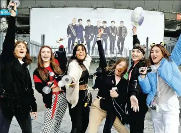  ?? AFP ?? Fans react as they arrive for a concert of the South Korean K-pop boy band BTS at the Stade-de-France stadium in Saint-Denis, on the outskirts of Paris, on June 7.