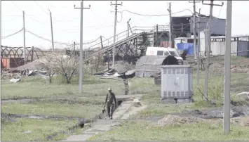  ??  ?? A miner walks at the coal mine of Skhidkarbo­n company following an alleged methane explosion near the separatist-controlled city of Luhansk. — Reuters photo