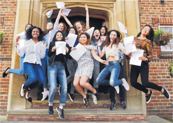  ??  ?? Jumping for joy: students celebrate their exam results, and a mother, below, shares her daughter’s excitement