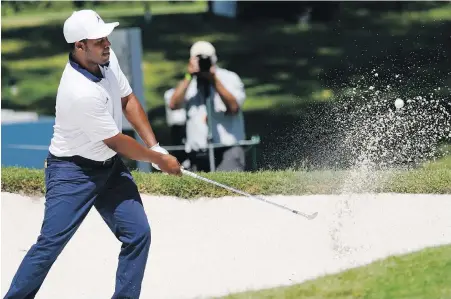  ??  ?? Second-round leader Harold Varner III blasts out of the sand near the eighth green during the second round of the Charles Schwab Challenge at the Colonial Country Club in Fort Worth, Texas, on Friday.