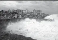  ?? AP ?? Indian people watch Saturday as high waves caused by Cyclone Phailin slam into the Bay of Bengal coastline in Visakhapat­nam.