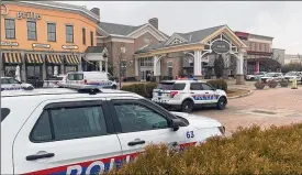  ?? COURTNEY HERGESHEIM­ER / COLUMBUS DISPATCH ?? Columbus police cruisers outside the main entrance of Polaris Fashion Place after gunshots were reported Monday — the second time in two weeks shots were reported fired inside the mall.