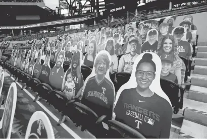  ?? KEVIN JAIRAJ/USA TODAY SPORTS ?? Cardboard cutouts of Rangers fans filled some of the seats in the lower stands in the first MLB regular-season game at Globe Life Field.