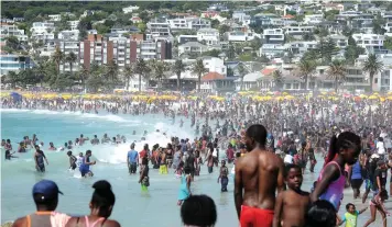  ?? Agency (ANA) COURTNEY AFRICA African News ?? CAMPS Bay beach was packed as visitors made the most of the first day of the new year on Tuesday. | AFRICAN NEWS AGENCY