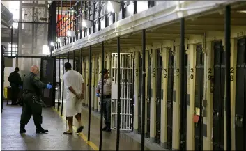  ?? AP Photo/ErIc rIsbErg ?? In this 2016 file photo, a condemned inmate is led out of his east block cell on death row at San Quentin State Prison in San Quentin, Calif.