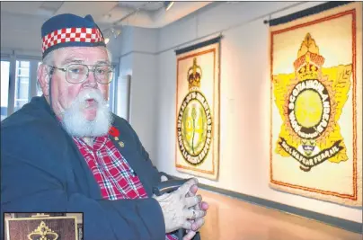  ?? ELIZABETH PATTERSON/CAPE BRETON POST ?? Leonard Boudreau of Sydney, former battalion adjutant of 2nd Battalion Nova Scotia Highlander­s (CB), takes a moment to reflect while his tapestries depicting the hat badges of local infantry battalions hang in the background at the Cape Breton Centre for Craft and Design in downtown Sydney.