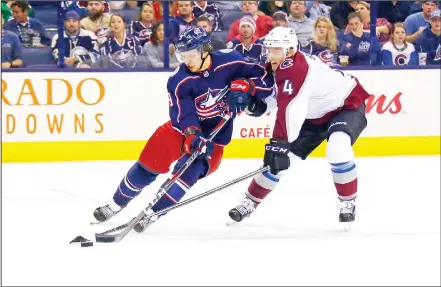  ??  ?? Tyson Barrie #4 of the Colorado Avalanche attempts to steal the puck from Artemi Panarin #9 of the Columbus Blue Jackets during the second period onOct 9 at Nationwide Arena in Columbus, Ohio. (AFP)