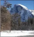  ?? National Park Service ?? The famous Half Dome towers up over the snowy Yosemite National Park in the winter. The park is less crowded and offers different activities for winter visitors.