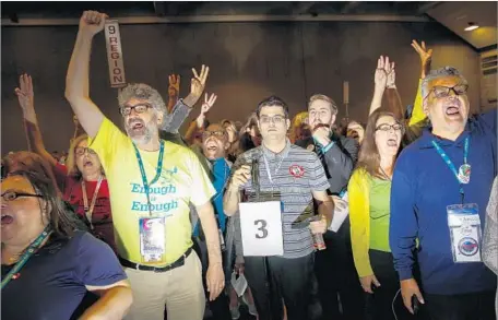  ?? Photograph­s by Jay L. Clendenin Los Angeles Times ?? DELEGATES at the state Democratic Party’s convention chant in support of Kimberly Ellis, who drew backing from many “Berniecrat­s.”