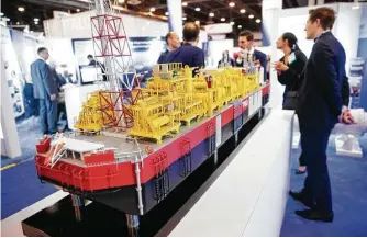  ?? Michael Ciaglo / Houston Chronicle ?? Convention­eers examine an exhibit Monday at the Offshore Technology Conference at NRG Center.