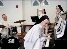  ?? The Washington Post/ASTRID RIECKEN ?? Miriam Holzman, piano; Louis Marie Zogg (right) saxophone; Mary Andre Thelen (second from right) trumpet; and Brad Elliott (left) drums; practice with their band Force of Habit.