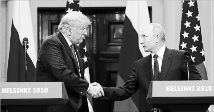  ?? ALEXANDER ZEMLIANICH­ENKO THE ASSOCIATED PRESS ?? U.S. President Donald Trump, left, shakes hand with Russian President Vladimir Putin during a press conference in Helsinki on Monday.