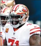  ?? ELSA/GETTY IMAGES ?? Trent Williams (71) of the San Francisco 49ers smiles during warm-ups before a 2020 game. The 49ers have reportedly agreed to terms with Williams on a six-year contract worth up $138 million.