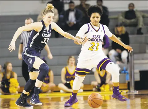  ?? Gerry Broome / Associated Press ?? UConn’s Katie Lou Samuelson, left, and East Carolina’s Dominique Claytor chase the ball during the second half on Wednesday in Greenville, N.C.