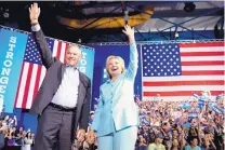  ?? ANDREW HARNIK/ASSOCIATED PRESS ?? Democratic presidenti­al candidate Hillary Clinton and her pick for vice president, Sen. Tim Kaine, D-Va., arrive at a rally at Florida Internatio­nal University Panther Arena in Miami on Saturday.